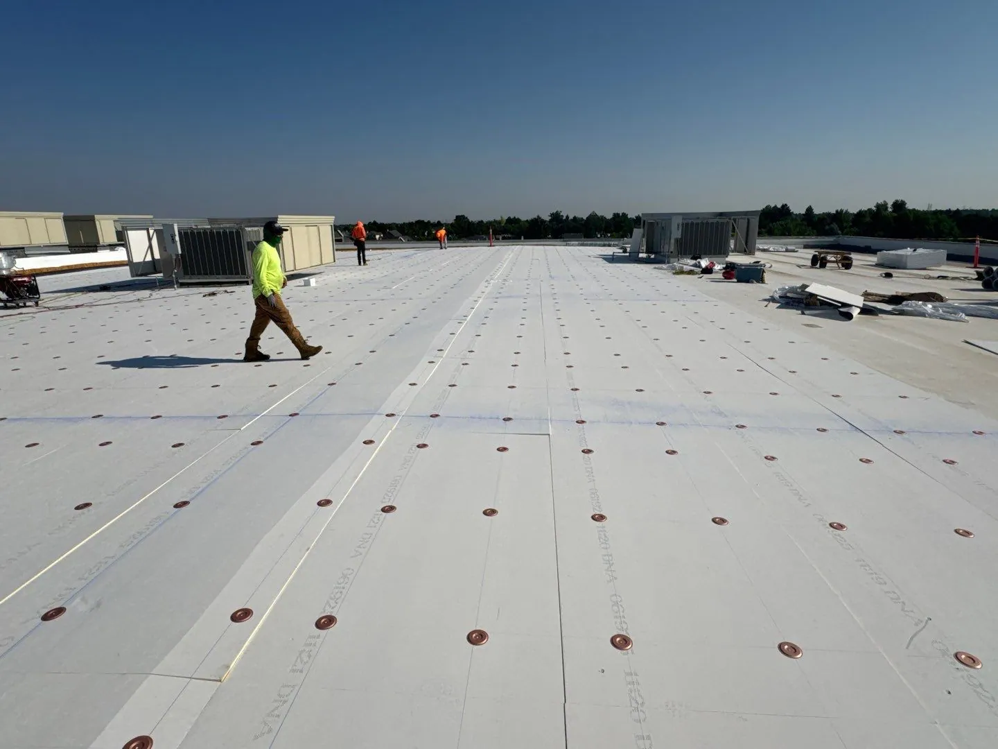 Peak to Peak Roofing crew completing commercial roof repair in Denver
