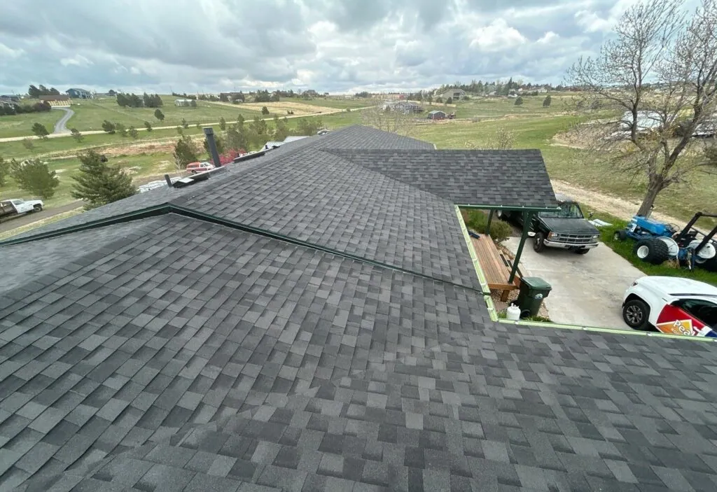 Shingle bundles staged across a Denver roof deck during replacement