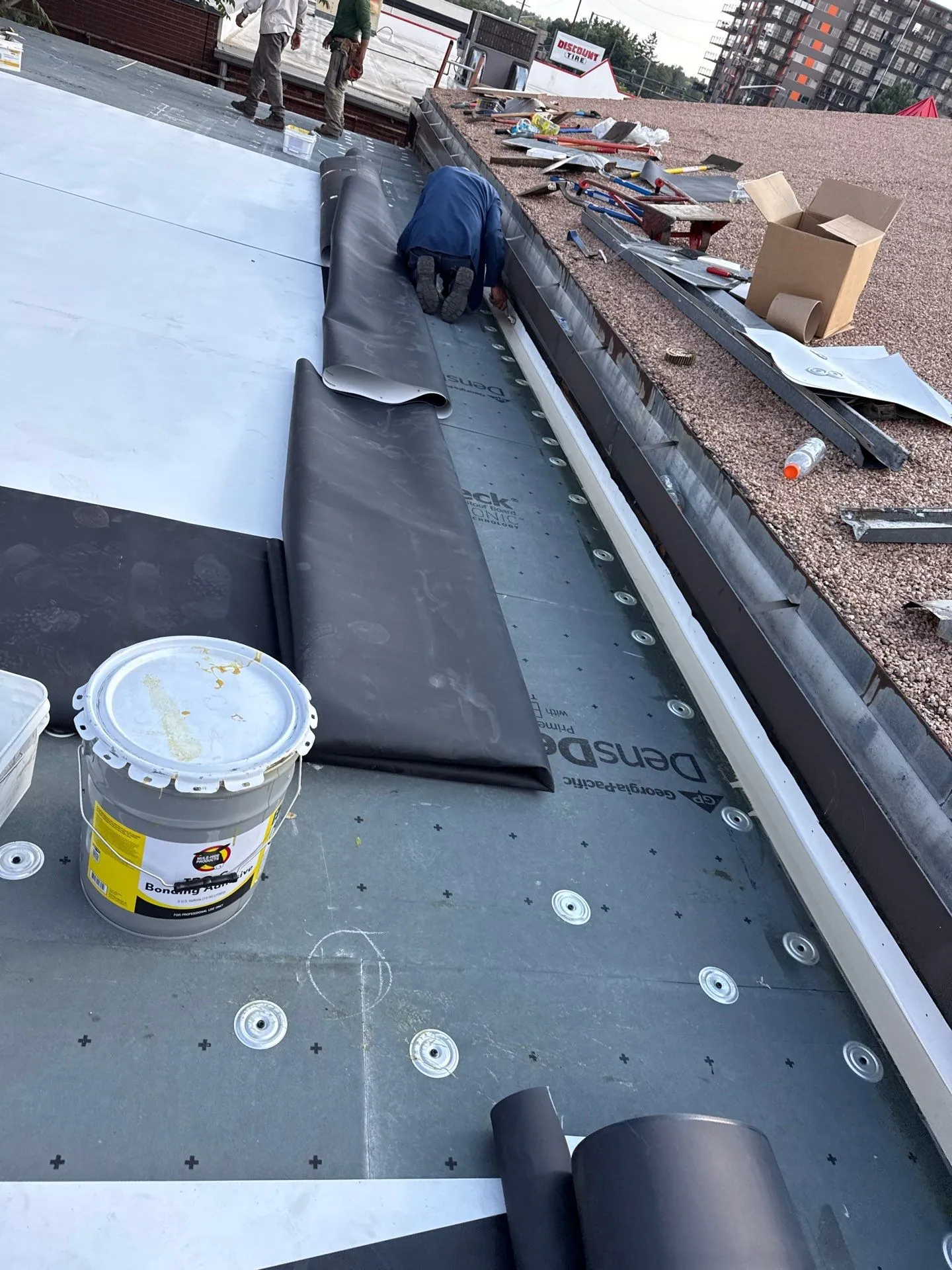 Peak to Peak Roofing crew completing commercial roof replacement in Denver