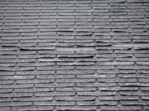 Weather-Damaged Shingles Needing Repair by Colorado Commercial Roofing Experts