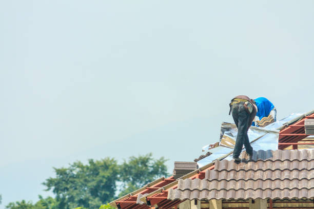  Construction roofer installing roof tiles at house